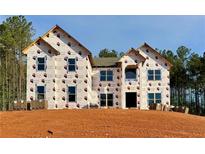 New construction two-story home with visible wrap and stacked brick and window installation preparation at 218 Lotus Ln, Covington, GA 30016