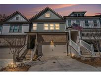 Charming townhome with well-maintained landscaping, a two-car garage, and inviting curb appeal at sunset at 233 Retreat Ln, Canton, GA 30114