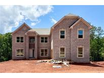 New two-story brick home featuring large windows, a covered porch, and architectural details at 255 Lotus Ln, Covington, GA 30016