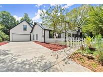 Charming two-story home featuring a white picket fence, a two-car garage, and a well-manicured lawn at 270 Piedmont Ne Rd, Marietta, GA 30066
