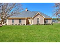 Inviting single-story home featuring a well-manicured lawn, neutral stucco, and a classic roof design at 3500 Patrick Manor Dr, Loganville, GA 30052