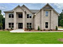 Beautiful two-story brick home with lush green lawn and classic architectural design at 221 Lotus Ln, Covington, GA 30016