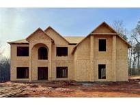 New construction home showing the exterior framing with gable roof and arched entryway at 221 Lotus Ln, Covington, GA 30016