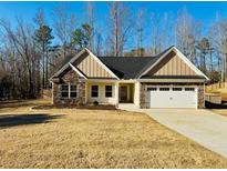 Charming single-story home with stone accents, attached two-car garage, and manicured lawn at 415 Smallwood Lane, Douglasville, GA 30134