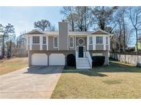 Charming two-story home featuring a two-car garage and inviting front porch with nice landscaping at 600 Canterbury Ln, Lawrenceville, GA 30046