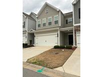 Charming two-story townhome with a one-car garage and well-maintained landscaping at 501 Crescent Woode Dr, Dallas, GA 30157