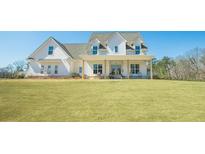 Charming two-story home featuring a welcoming front porch and a well-manicured lawn at 774 Forrester Cemetery Rd, Covington, GA 30014