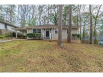 Charming single-story home with a manicured lawn and mature trees offering curb appeal at 1624 Linda Dr, Decatur, GA 30032