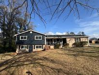 Charming two-story home features a combination of stone and siding exterior with a well-maintained front yard at 3633 Mill Glen Dr, Douglasville, GA 30135