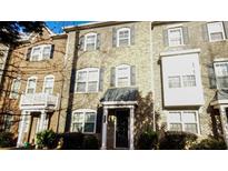 Charming townhome featuring a classic brick facade and well-maintained landscaping for appealing curb appeal at 2444 Tenor Ln, Alpharetta, GA 30009
