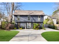 Charming two-story home with a modern exterior, large windows, and well-manicured lawn at 2824 Tupelo Se St, Atlanta, GA 30317