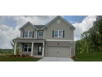 Charming two-story home featuring a gray exterior, brick accents, and an attached two-car garage at 6005 Spring Way, Stonecrest, GA 30038