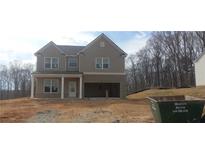 Charming two-story home with a brick-accented garage and covered front porch, nestled on a spacious lot at 6005 Spring Way, Stonecrest, GA 30038