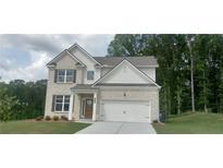 Charming two-story home features a brick facade, attached two car garage, and a manicured front lawn at 6015 Spring Way, Stonecrest, GA 30038