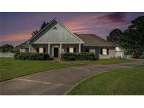 Charming one-story home boasts mature landscaping and a welcoming front porch at 950 Sundew Se Dr, Conyers, GA 30013