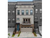 Charming three-story townhouse with brick and neutral siding, featuring a balcony and attached garage at 1049 Brandsford Nw St # 27-01, Atlanta, GA 30318