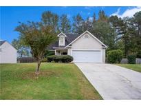 Charming single-Gathering home with well-maintained lawn and two-car garage in a suburban neighborhood at 142 Parkside Dr, Stockbridge, GA 30281