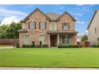 Charming two-story brick home featuring a manicured lawn and inviting curb appeal at 5310 Corinth Ct, Cumming, GA 30040