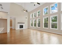 Bright living room with hardwood floors, fireplace and large windows providing an abundance of natural light at 537 Pearl St, Cumming, GA 30040