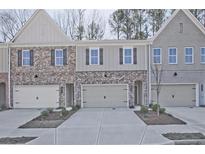 New townhome exterior showing brick facade, garage, and a sidewalk leading to the front door at 4667 Larkfield Way, Powder Springs, GA 30127