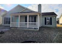 Charming single-story home featuring a covered front porch and manicured lawn at 5778 Eagles Feather Ln, Riverdale, GA 30274