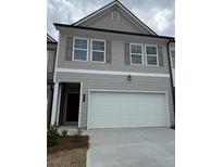 Two-story townhome features a gray exterior, shuttered windows, and a two-car garage at 1118 Edinburg Dr # 60, Villa Rica, GA 30180