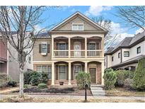 Charming two-story home featuring a double porch and landscaped front yard at 1596 Baxley Pine Trce, Suwanee, GA 30024
