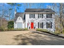 Charming two-story white home featuring a bright red front door and traditional black shutters at 1347 Independence Way, Marietta, GA 30062
