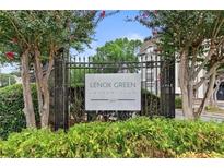 Well-maintained condominium entrance with mature trees and manicured landscaping at 2657 Lenox Rd # F84, Atlanta, GA 30324