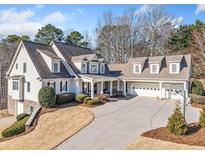 Stunning home featuring a circular driveway, large windows, and a three-car garage at 332 William Dr, Canton, GA 30114
