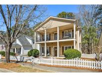 Charming two-story home featuring a double front porch and a white picket fence at 4612 Liberty Square Dr, Acworth, GA 30101