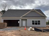 Charming single-story home with a garage, neutral siding, and a classic roof, ready for personalization and landscaping at 4755 Fowler St, Acworth, GA 30101