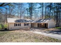 Charming ranch-style home with a cozy, covered carport and a well-maintained lawn at 5305 Pilgrim Point Rd, Cumming, GA 30041