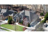 Beautiful home featuring stone accents, multiple garage spaces, mature landscaping, and a circular driveway at 78 Cuthbert Ln Ne, Acworth, GA 30101