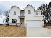 New two-story home featuring white siding, brick accents, an attached two-car garage, and a freshly seeded front yard at 120 Cedar Cliff Ct, Temple, GA 30179