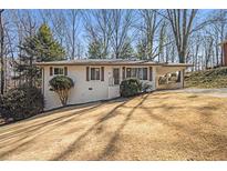 Charming single story home with a carport, front lawn and mature trees at 46 Cooper Lake Sw Rd, Mableton, GA 30126