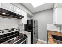 Bright kitchen with subway tile backsplash and stainless steel refrigerator at 117 Lablanc Nw Way, Atlanta, GA 30327