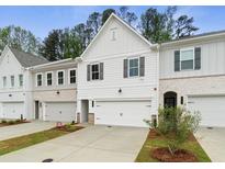 View of newly built townhomes with white siding, gray shutters, and attached garages at 1612 Ruskin Way, Marietta, GA 30062