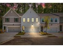Charming townhome with a two-car garage, freshly manicured lawn, and inviting curb appeal at 1624 Ruskin Way, Marietta, GA 30062