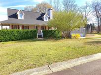 Charming two-story home featuring a well-maintained lawn and lush green hedges at 345 Lambeth Dr, Hiram, GA 30141