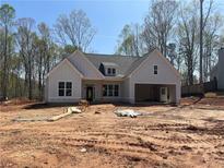 Striking new construction home with white board and batten siding and attached two car garage at 270 Harmony Woods Dr, Dallas, GA 30157