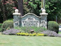 Community entrance sign featuring the property address and neighborhood name, surrounded by manicured landscaping at 3510 Nw Roswell Nw Rd # J1, Atlanta, GA 30305