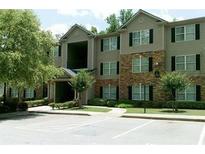 Attractive apartment building featuring stone accents and lush landscaping at 5101 Fairington Club Dr, Lithonia, GA 30038