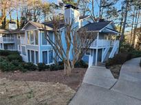 Charming, light blue two-story home featuring a cozy balcony and well-maintained landscaping at 1644 Alexandria Ct, Marietta, GA 30067