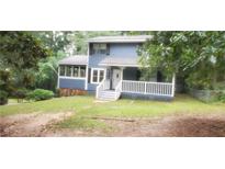 Charming two-story home with blue siding, covered front porch, and mature trees at 4473 Marjorie, Snellville, GA 30039