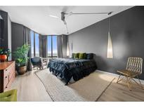 This primary bedroom suite features floor-to-ceiling windows, a ceiling fan, and designer lighting at 2870 Pharr Ct # 3002, Atlanta, GA 30305