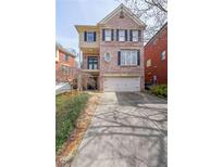 Charming three-story brick home with a two-car garage and inviting curb appeal at 2476 Manor Walk, Decatur, GA 30030