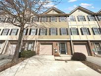 Charming townhome featuring a cozy front door, garage, and tidy landscaping at 6206 Redan Overlook, Lithonia, GA 30058