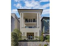 Stunning exterior elevation featuring a stucco facade, black accents, and a charming balcony at 81 Delmont Ne Dr, Atlanta, GA 30305