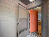 Inviting entryway featuring a vibrant front door and a screen door, leading into a cozy interior at 30 Finch Ne Trl, Atlanta, GA 30308